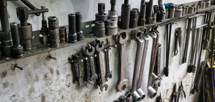 a bunch of tools are hanging on a wall